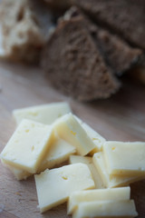 the cheese cheddar is on the plate with bread