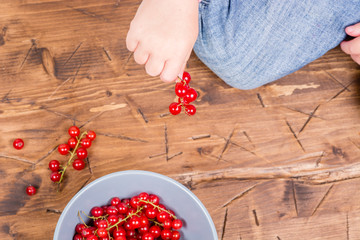 red currants on a wooden background