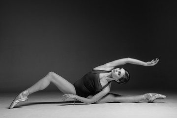 Young beautiful dancer is posing in studio