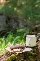 Snack with bacon (pork) and hot drink in the morning forest. Copy space