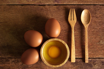 eggs with wood spoon on wood  background.
