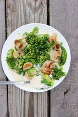 Nutritious dish of roasted pork fillet, green pepper, greens, broccoli in cream