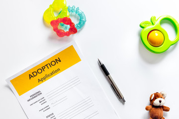 Adoption application near paper silhouette of family and toys on white background top view copyspace