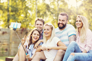 Happy group of friends taking selfie outdoors