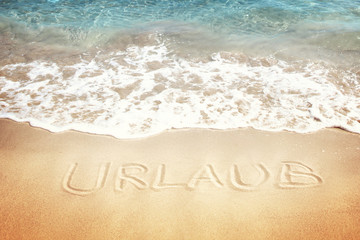 Urlaub geschrieben auf dem Sand