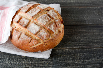 Homemade bread on a wooden background.