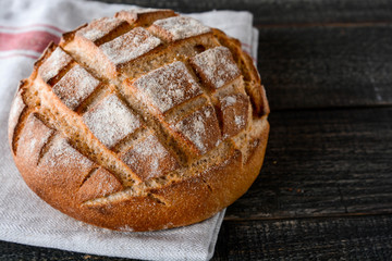 Homemade bread on a wooden background.