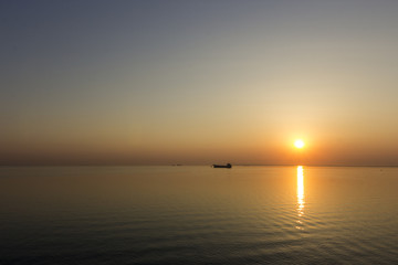 cargo ship straight to dawn horizon
