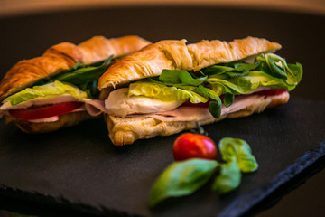 Sandwich with delicatessen cheese and fresh leaves salad.
