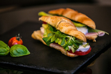 Sandwich with delicatessen cheese and fresh leaves salad.