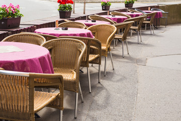 Old fashioned cafe terrace. Tables and wicker chairs in a cafe