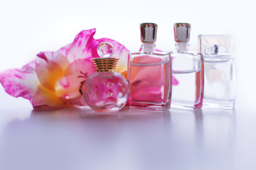 Different small bottle of perfume with pink flowers