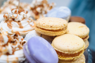 Fresh baked macaroon pastry cookies macarons, macaroni - French almond dessert. Candy bar for birthday patry celebration, childhood, abstract, shallow focus. Sweet table - desserts, macaroni, cake