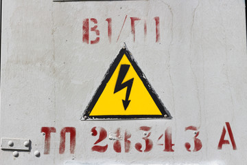 Sign "Caution high voltage" painted with paint on the door of the electrotransmitter