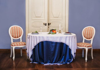 Dining table with appliances and two chairs next to each other