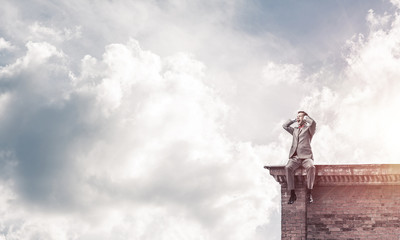 Young man on building roof dont want to hear anything