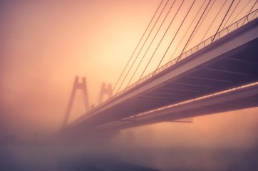 Cable stayed bridge, Krakow, Poland, in the morning fog over Vistula river
