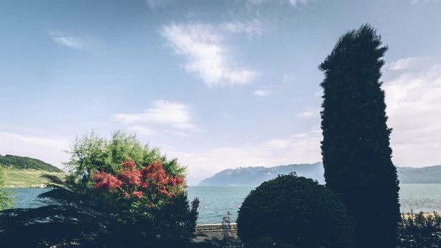Time lapse of passing clouds over the lake front promenade in Cully, Switzerland.