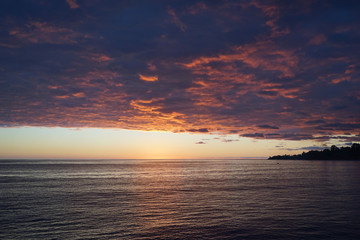 Seascape at sunset with heavy storm clouds in the sky