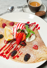 Strawberry, raspberry, blackcurrant, mint and lemon crepe served with ice cream, espresso coffee and a biscuit.