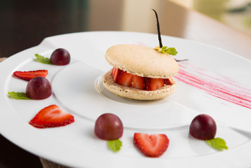 fresh strawberry and cream macaroons serves with grape and strawberry segments