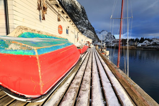 Small fishing boats ashore upon wooden pier-harbor's W.side. Hamnoy-Reine-Lofoten-Norway. 0232