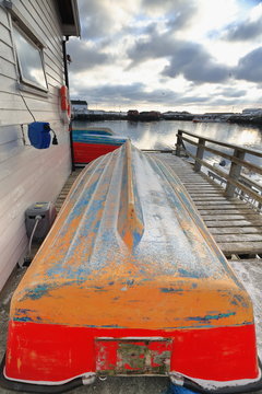 Small fishing boats ashore upon wooden pier-harbor's W.side. Hamnoy-Reine-Lofoten-Norway. 0237