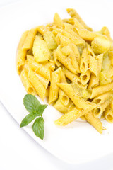 Penne with pesto and zucchini decorated with mint