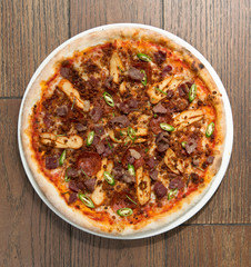 Spicy pepperoni, chicken and bacon pizza with jalapeño slices
