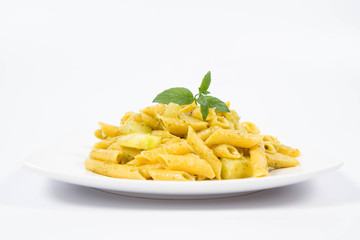 Penne with pesto and zucchini decorated with mint