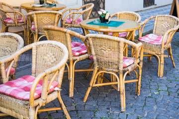 Old fashioned cafe terrace. Tables and wicker chairs in a cafe