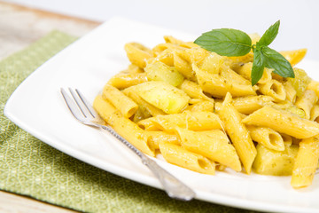 Penne with pesto and zucchini decorated with mint