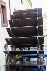 Working watermill wheel with falling water in the village