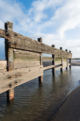 cleveleys, england, 02/17/2016, A rustic, weathered wooden sea defence wall, showing signs of damage...