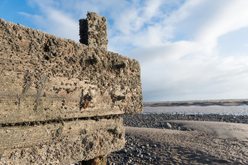 cleveleys, england, 02/17/2016, A rustic, weathered wooden sea defence wall, showing signs of damage and barnacle growth..