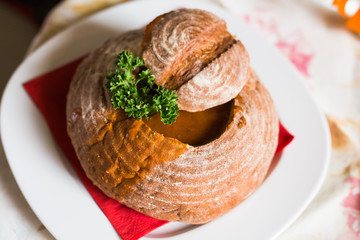 Meat soup in bread. A dish of Czech cuisine in the restaurant of Prague.