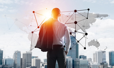 Concept of business success and control with confident boss against cityscape background