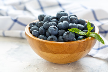 Fresh blueberries in a wooden bowl.