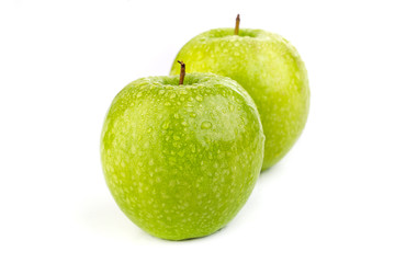 Bright ripe green apples in water drops