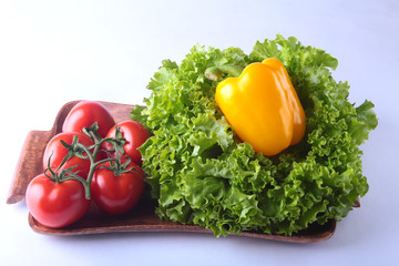 Fresh assorted vegetables bell pepper, tomato, garlic with leaf lettuce. Isolated on white background. Selective focus.