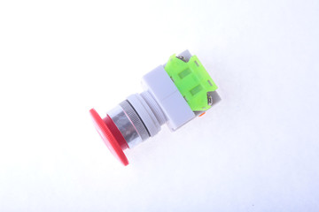 Close-up emergency stop button isolated on white background.