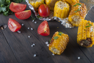 corn grilled on a wooden kitchen board with salt © vimart