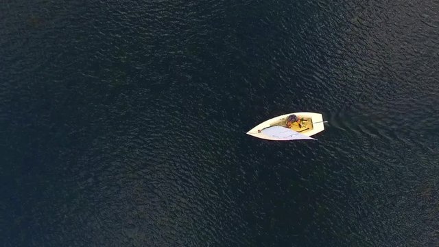 Unidentified yachtsman enjoying summer holidays on a lake. Yachting from above. Drone video on water sports theme.