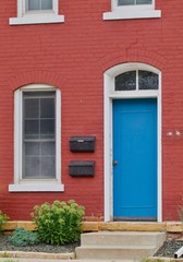 Fototapeta na wymiar Blue door, red house