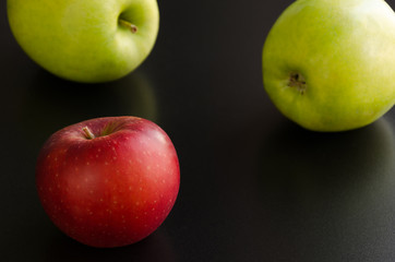 Three apples on a black background