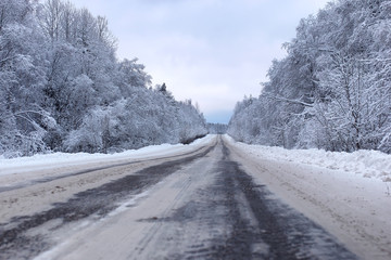 Fototapeta na wymiar landscape Road in the winter forest with snow covered