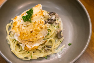 Spaghetti noodles with roasted chicken and mushrooms on a plate