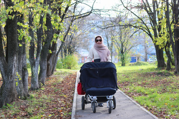 girl in the park with stroller