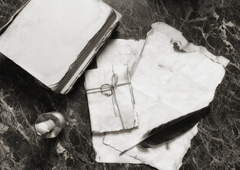 aged retro papers and book on table with detective tools background