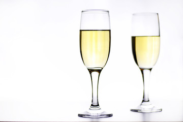 glass of white wine on a table on white background isolate